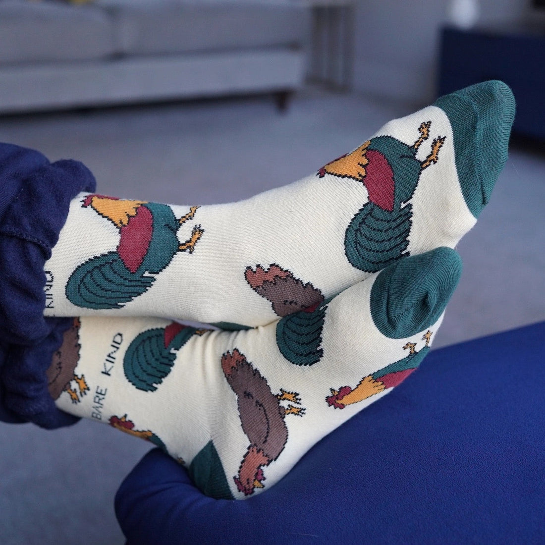 A pair of bamboo textile socks showing a chicken on someone's feet