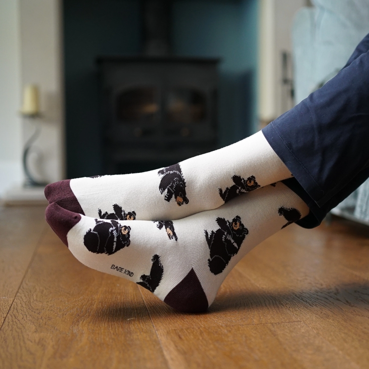 A pair of Bare Kind Bamboo Socks on feet in a casual home setting