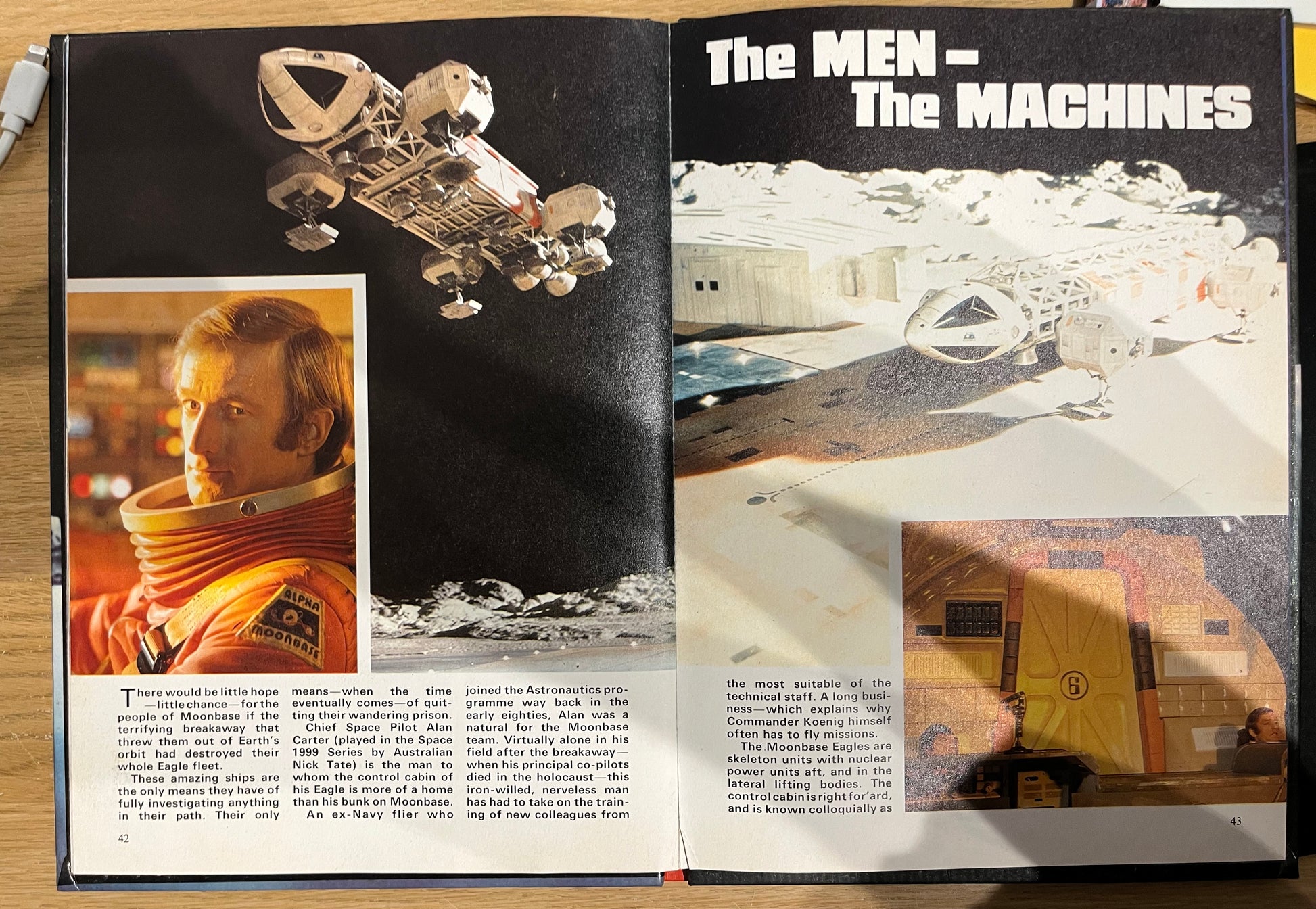 Open book with space-themed images and text 