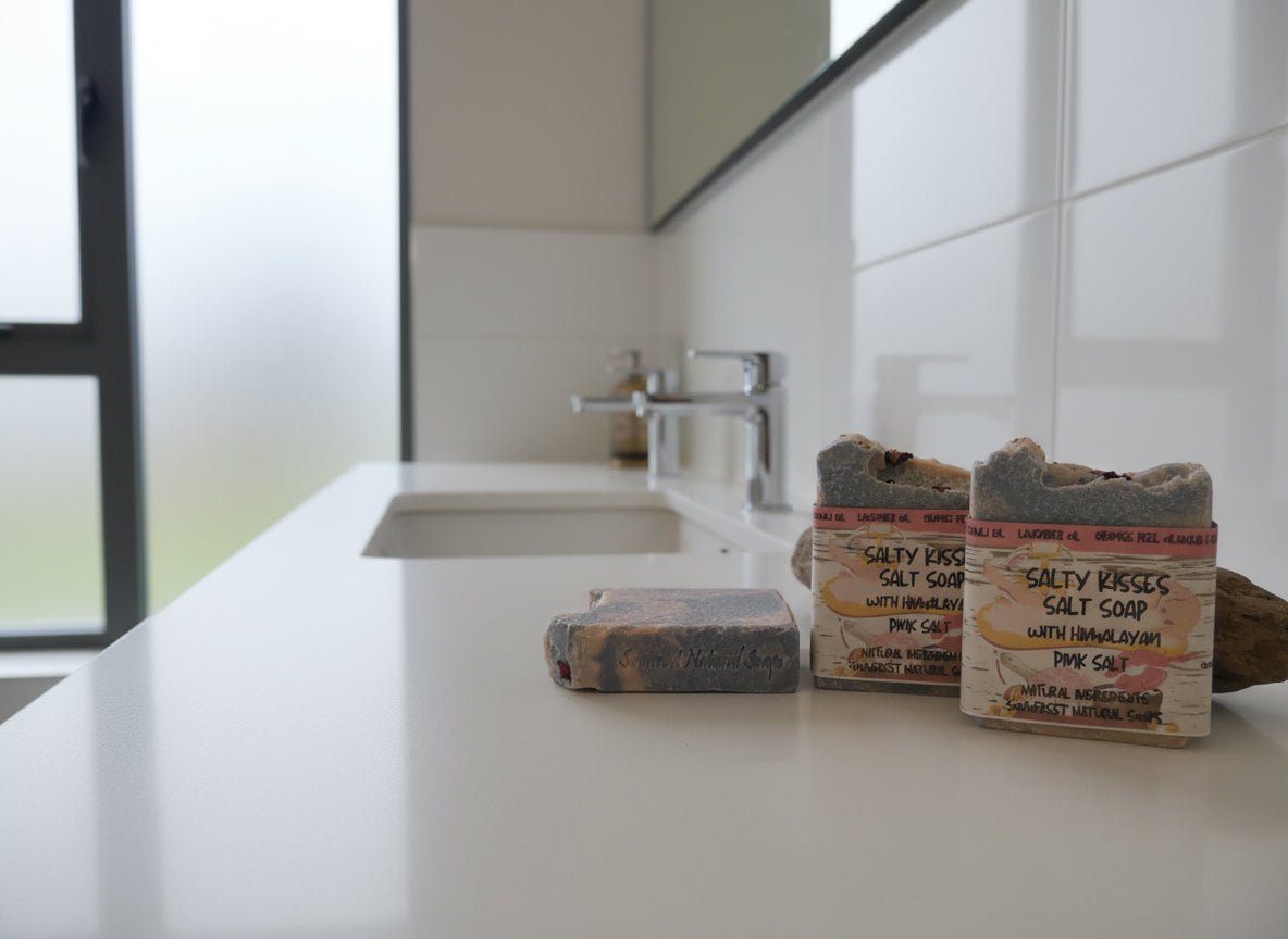 Two salt soaps with packaging on a white surface