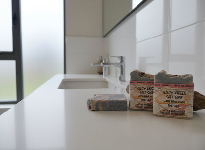 Two salt soaps with packaging on a white surface